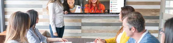 Group of colleagues on Teams call in meeting room