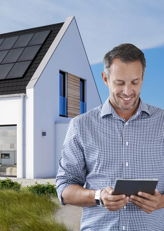 homeowner in front of solar powered home